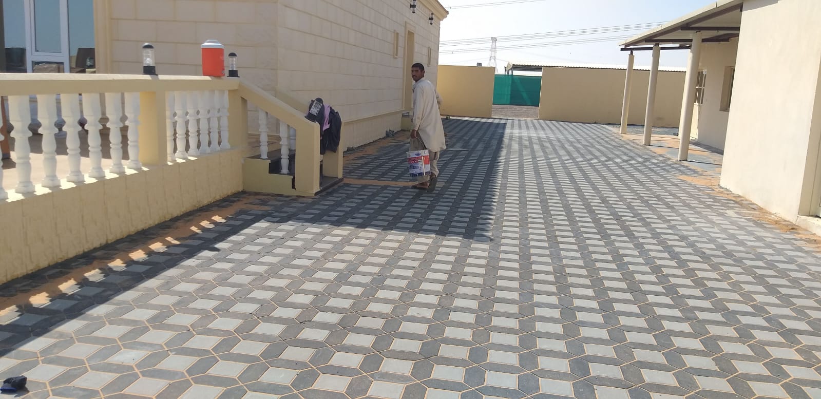 Geometric interlock courtyard at a private farmhouse in Al Wathba.