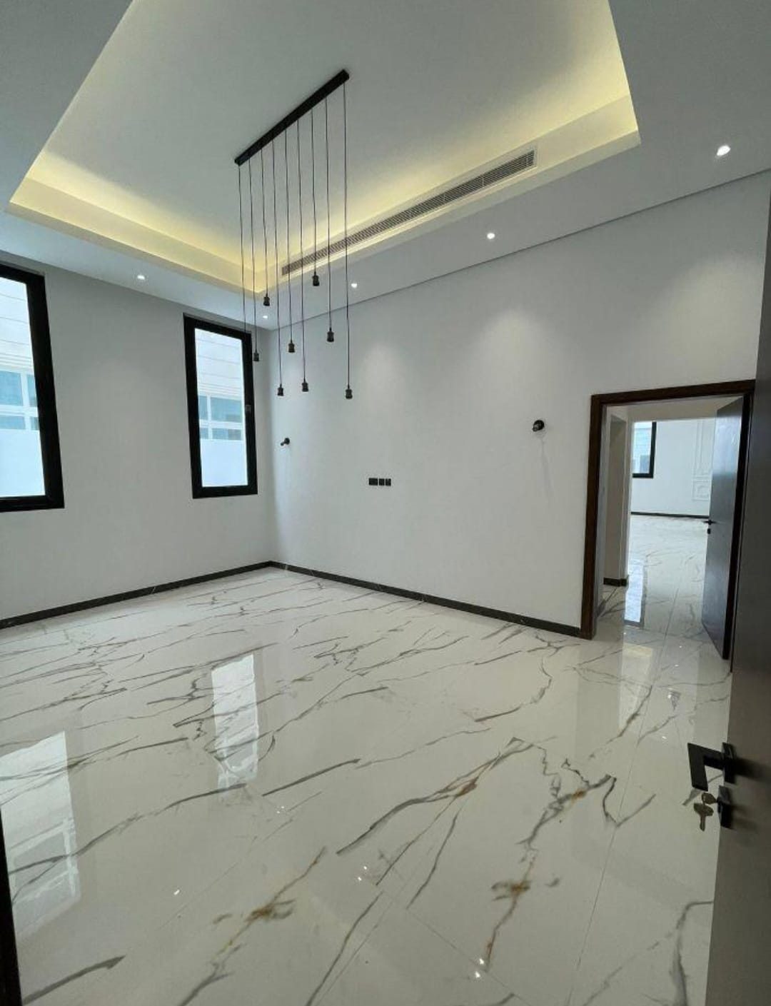Bright reception room with polished marble floor.