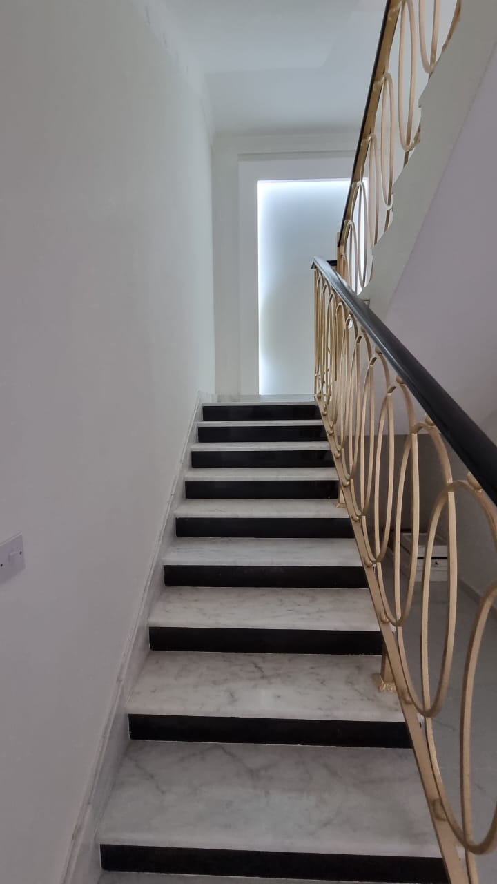Marble staircase with ornate railing, Al Rahba