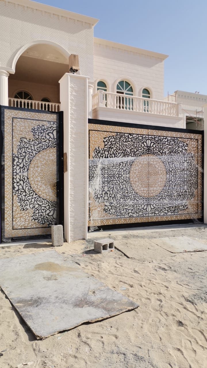 Decorative laser-cut gate at a villa entrance